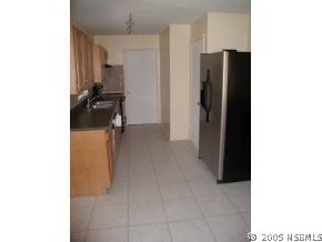568 Lambright Road Daytona Beach, FL 32119 - Photo 3 of 6 a view of a living room with furniture and a refrigerator
