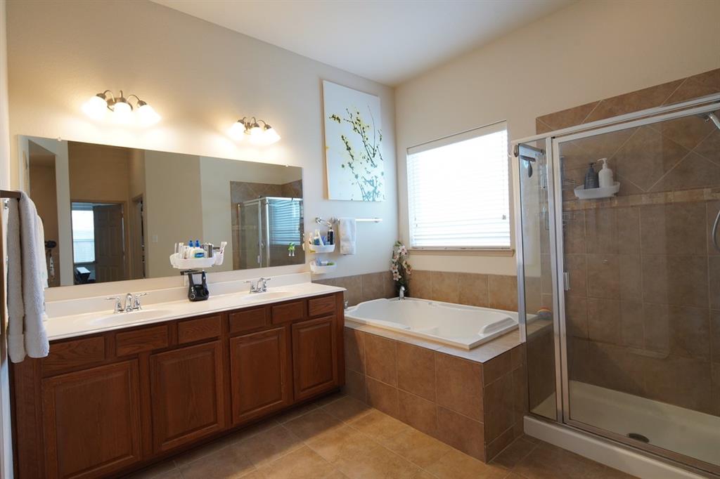 4508 Fox Rio Trail Arlington, TX 76017 - Photo 14 of 28 a en suite bathroom with a double vanity sink mirror and shower