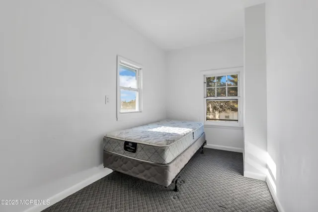 a room with a bed and a window