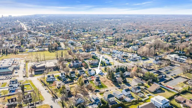 an aerial view of residential houses with city view