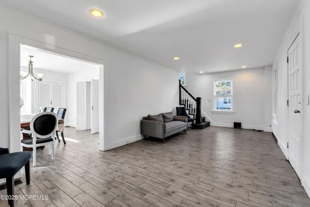 a living room with furniture and a mirror