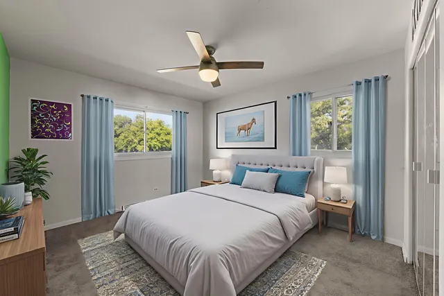 a bedroom with a large bed and a chandelier