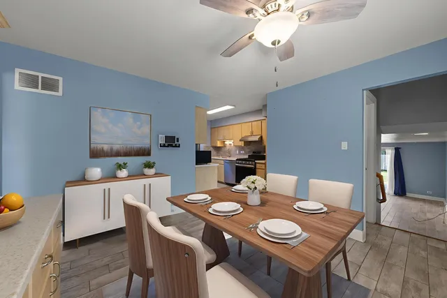 a view of a dining room with furniture and wooden floor