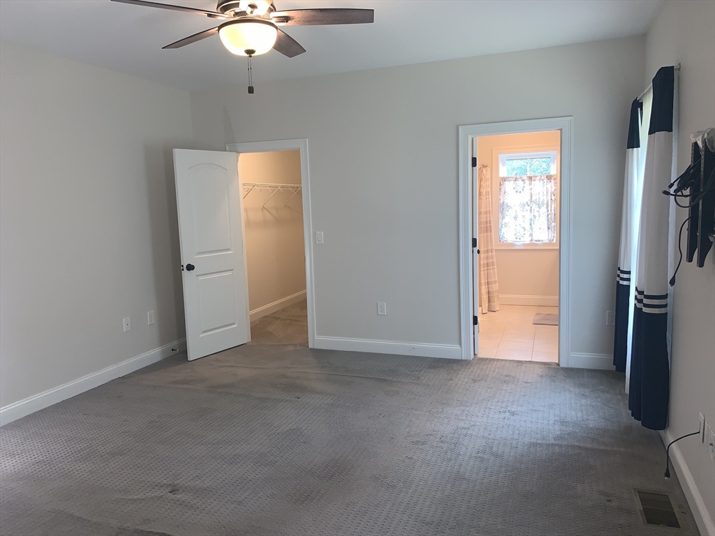 170 Pratt Pond Road Mason, NH 03048 - Photo 17 of 31 an empty room with closet and a chandelier fan
