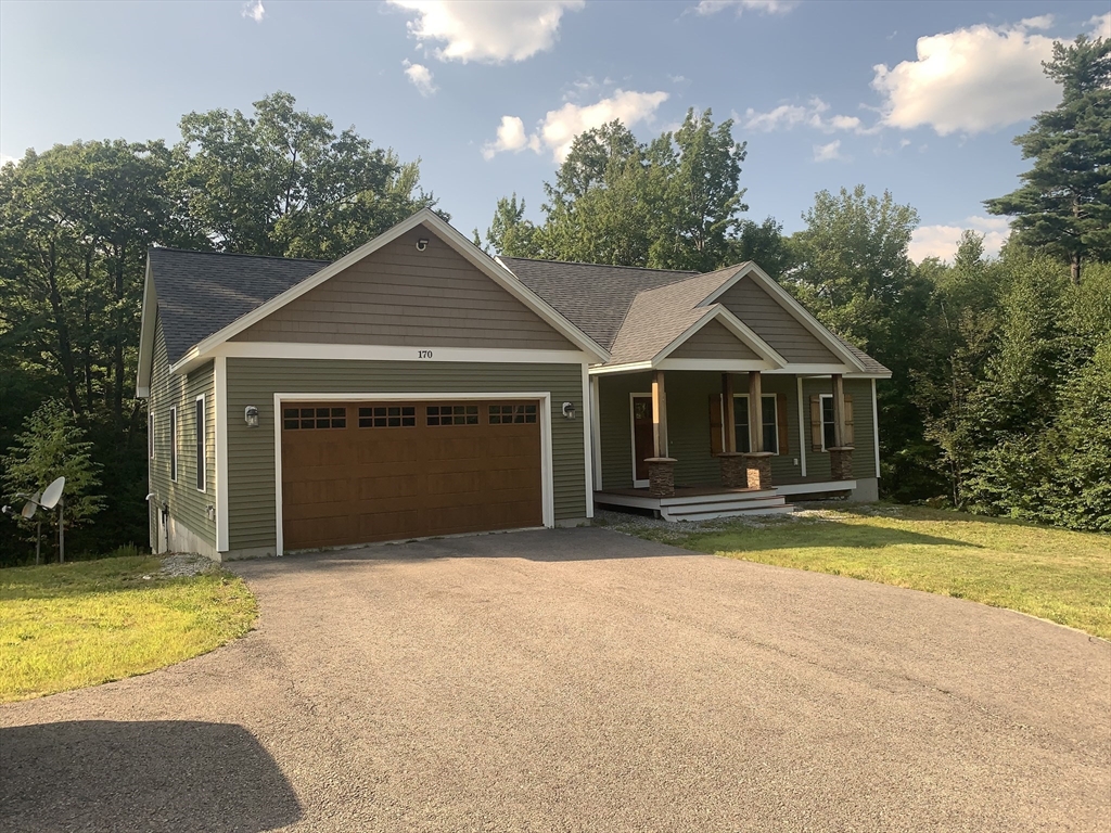 170 Pratt Pond Road Mason, NH 03048 - Photo 3 of 31 a front view of a house with a yard and garage