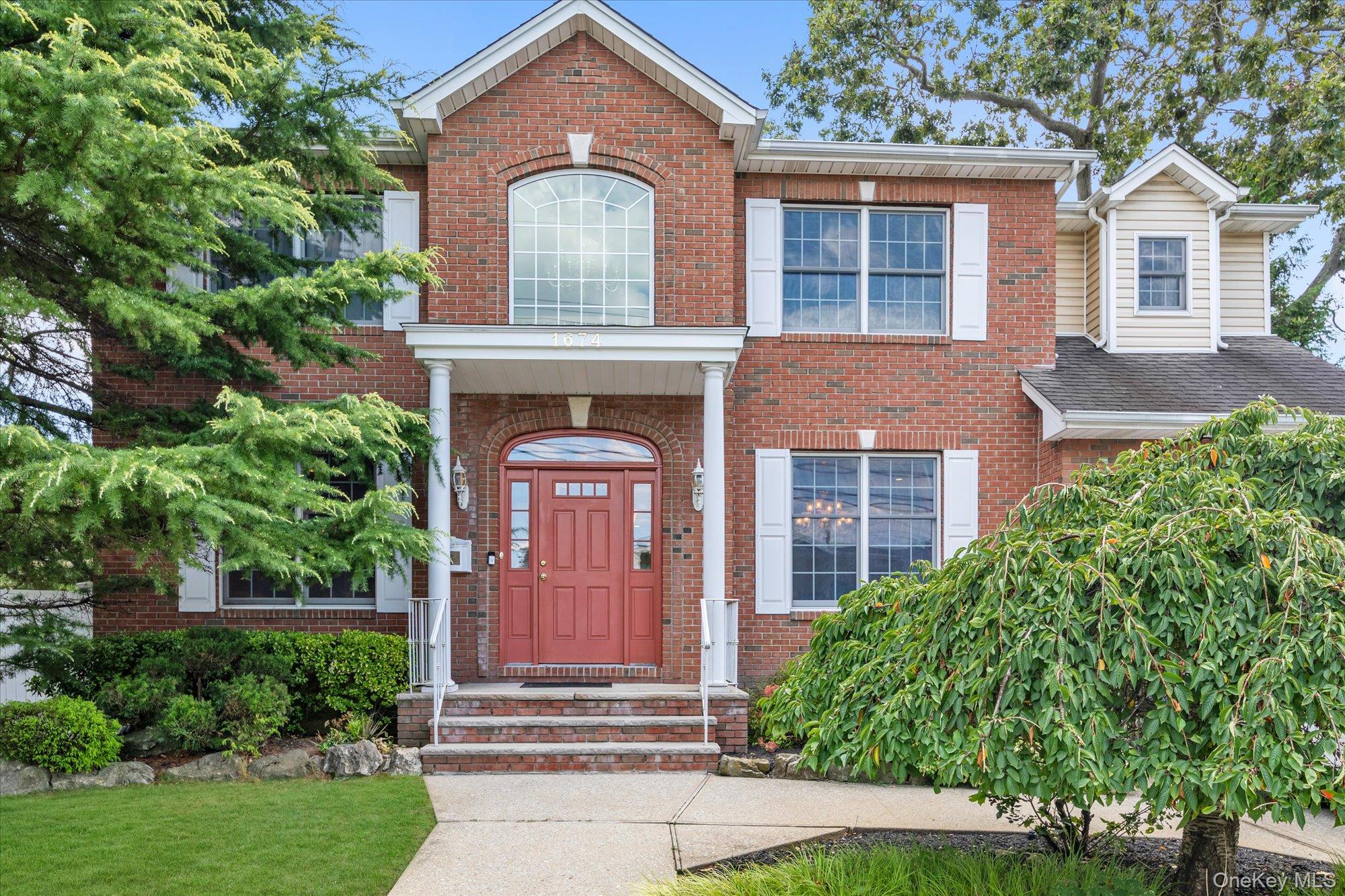 1674 Birch Drive Merrick, NY 11566 - Photo 1 of 1 front view of a house with a yard