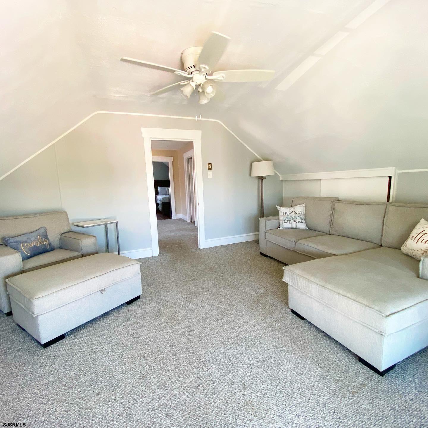 608 1st Street, Unit 3 Ocean City, NJ 08226 - Photo 3 of 13 a living room with furniture and a ceiling fan