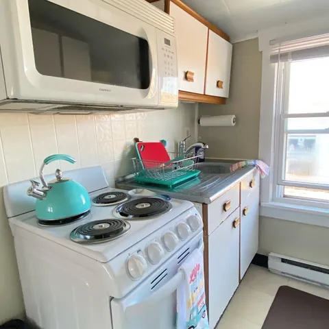 a kitchen with stainless steel appliances a stove a microwave and cabinets