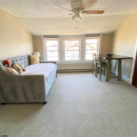 a spacious bedroom with a bed and a chandelier