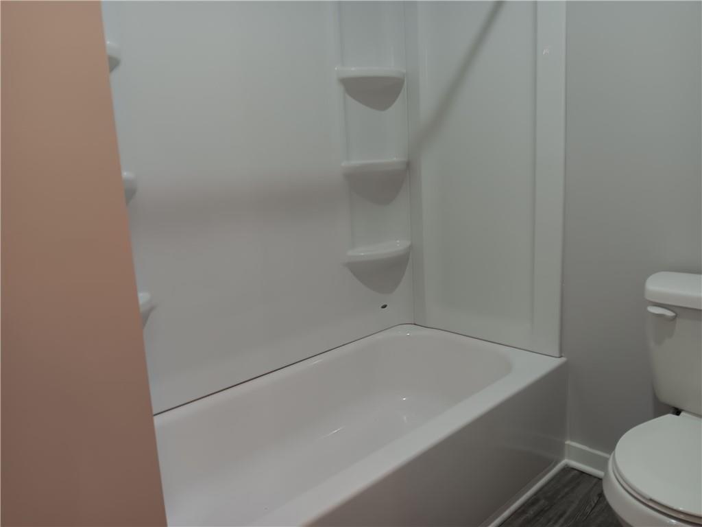 1112 Regent Street Southwest, Unit 1 Atlanta, GA 30310 - Photo 13 of 20 a white bath tub sitting next to a toilet