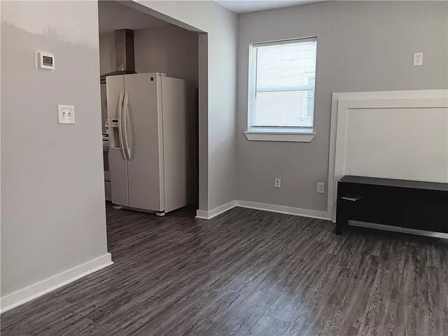 an empty room with wooden floor and a window