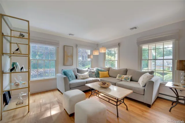 a living room with furniture a table and a chandelier