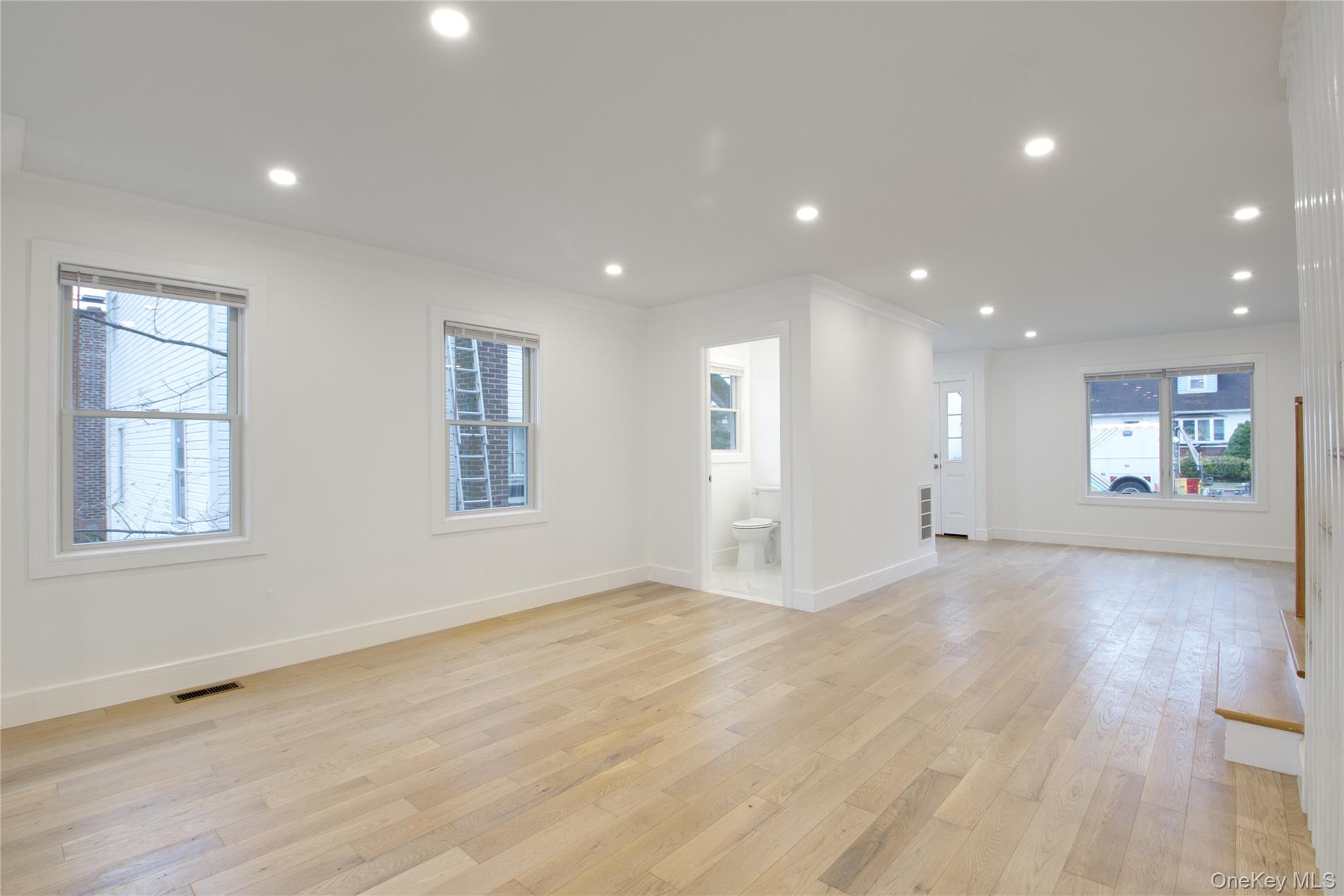 56 Kirkwood Road Port Washington, NY 11050 - Photo 12 of 46 an empty room with wooden floor and windows