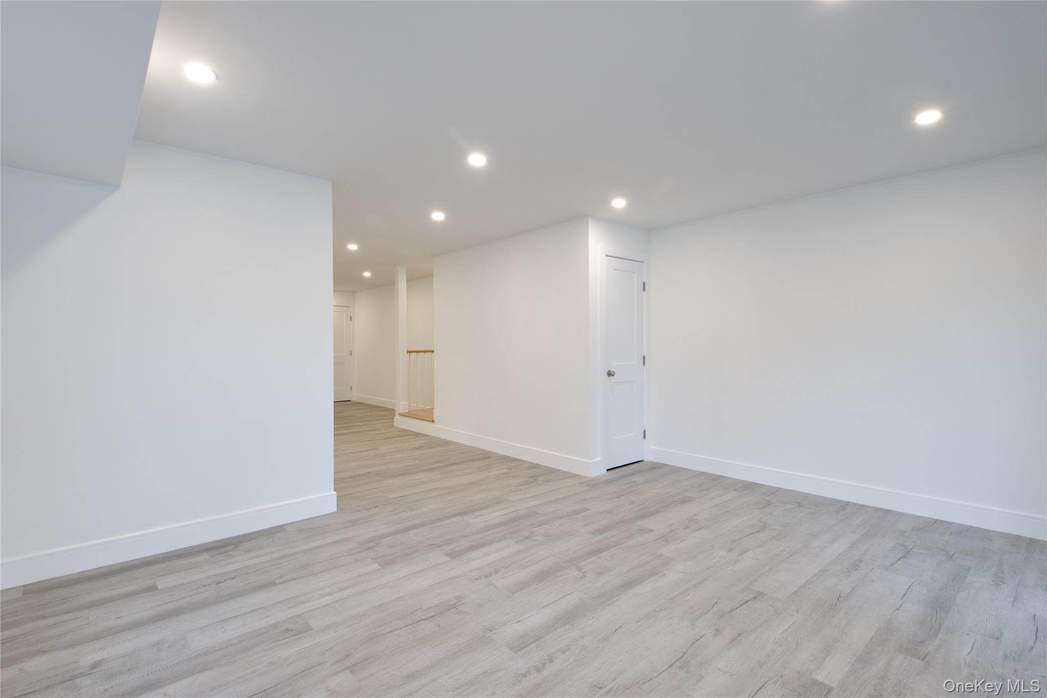 56 Kirkwood Road Port Washington, NY 11050 - Photo 20 of 46 a view of an empty room with wooden floor