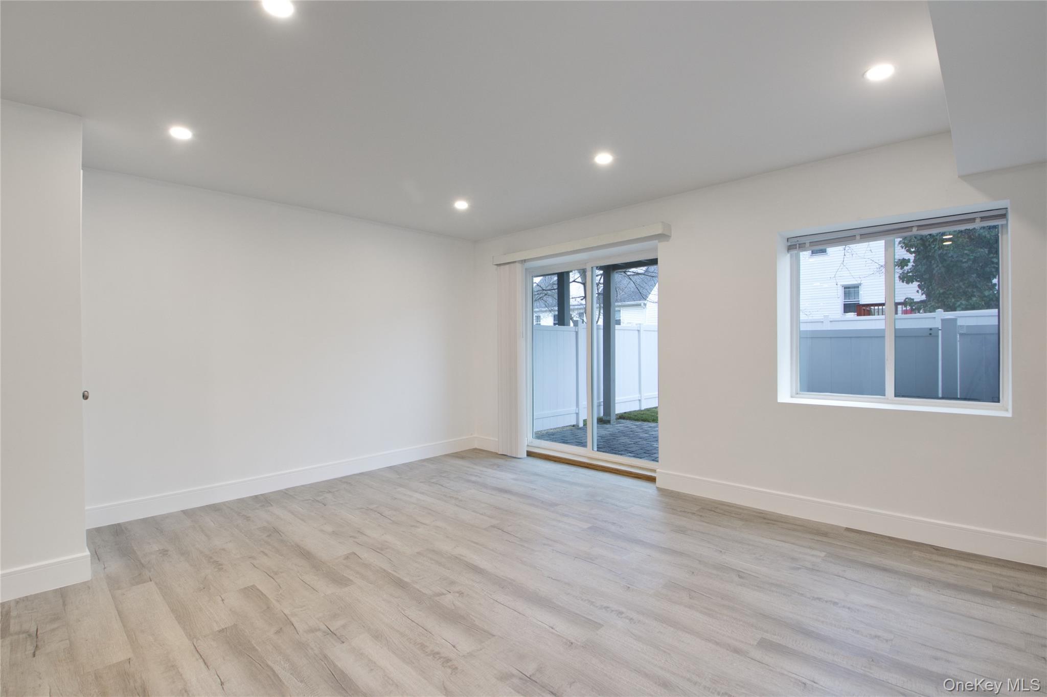 56 Kirkwood Road Port Washington, NY 11050 - Photo 21 of 46 a view of an empty room with wooden floor and a window