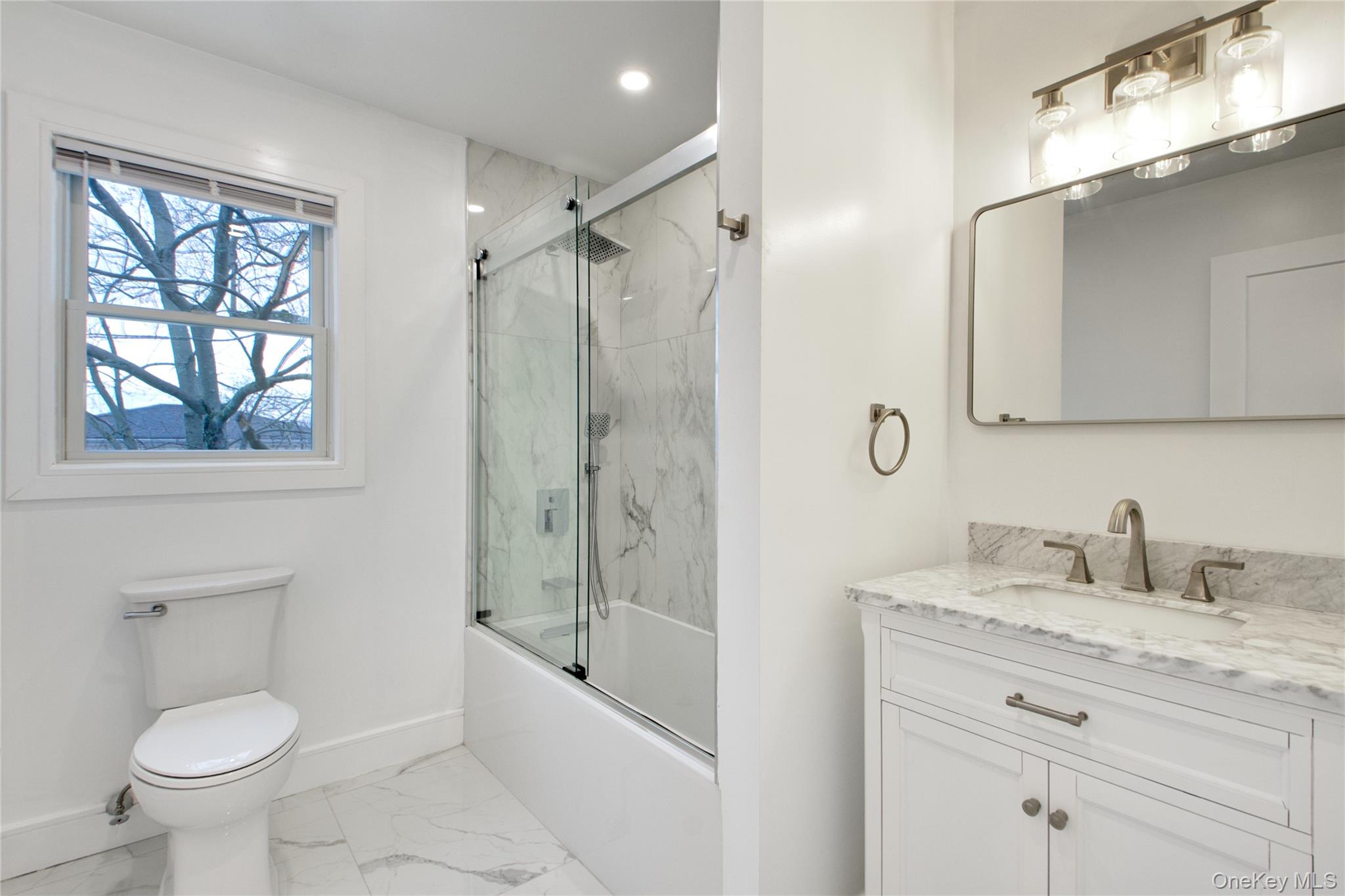 56 Kirkwood Road Port Washington, NY 11050 - Photo 23 of 46 a bathroom with a granite countertop sink a toilet and shower