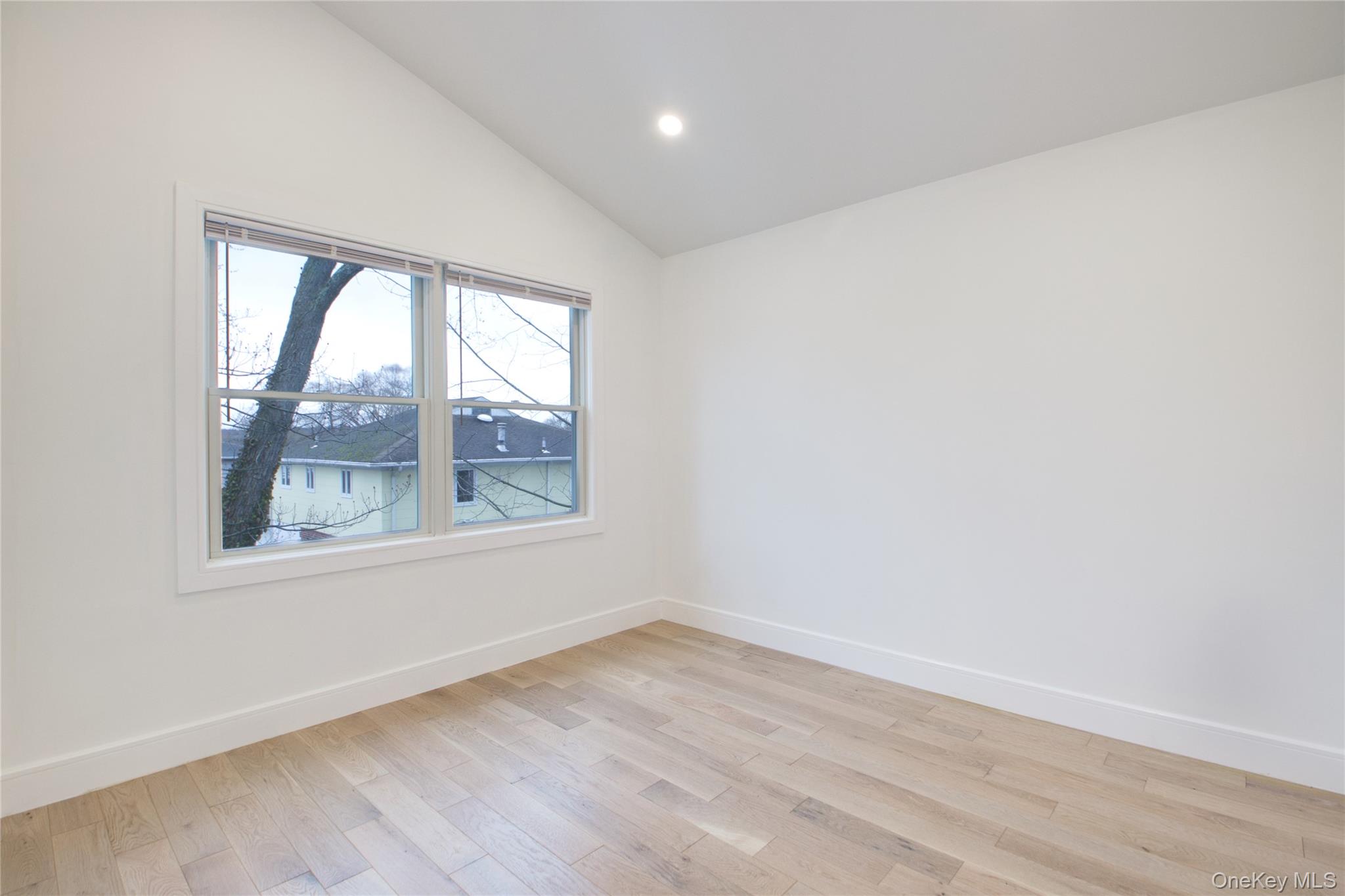 56 Kirkwood Road Port Washington, NY 11050 - Photo 25 of 46 an empty room with wooden floor and windows