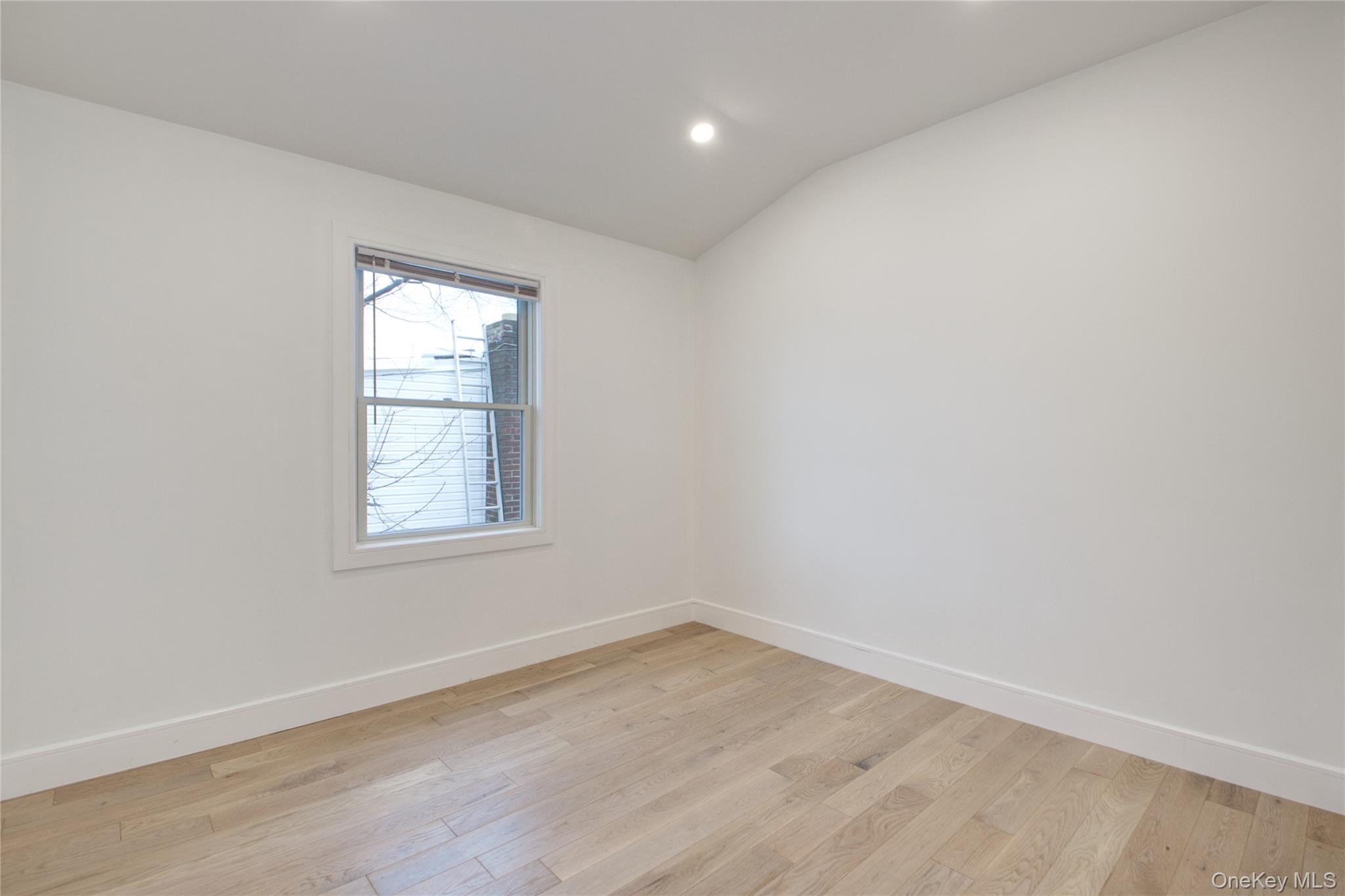 56 Kirkwood Road Port Washington, NY 11050 - Photo 27 of 46 an empty room with wooden floor and windows