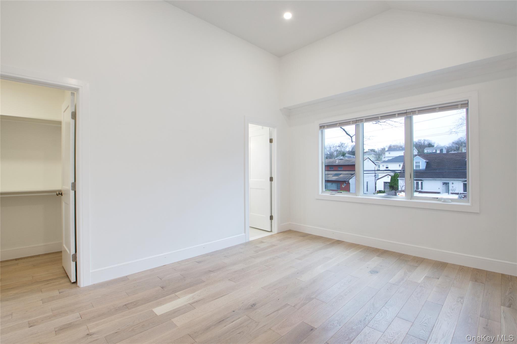 56 Kirkwood Road Port Washington, NY 11050 - Photo 28 of 46 an empty room with wooden floor and windows