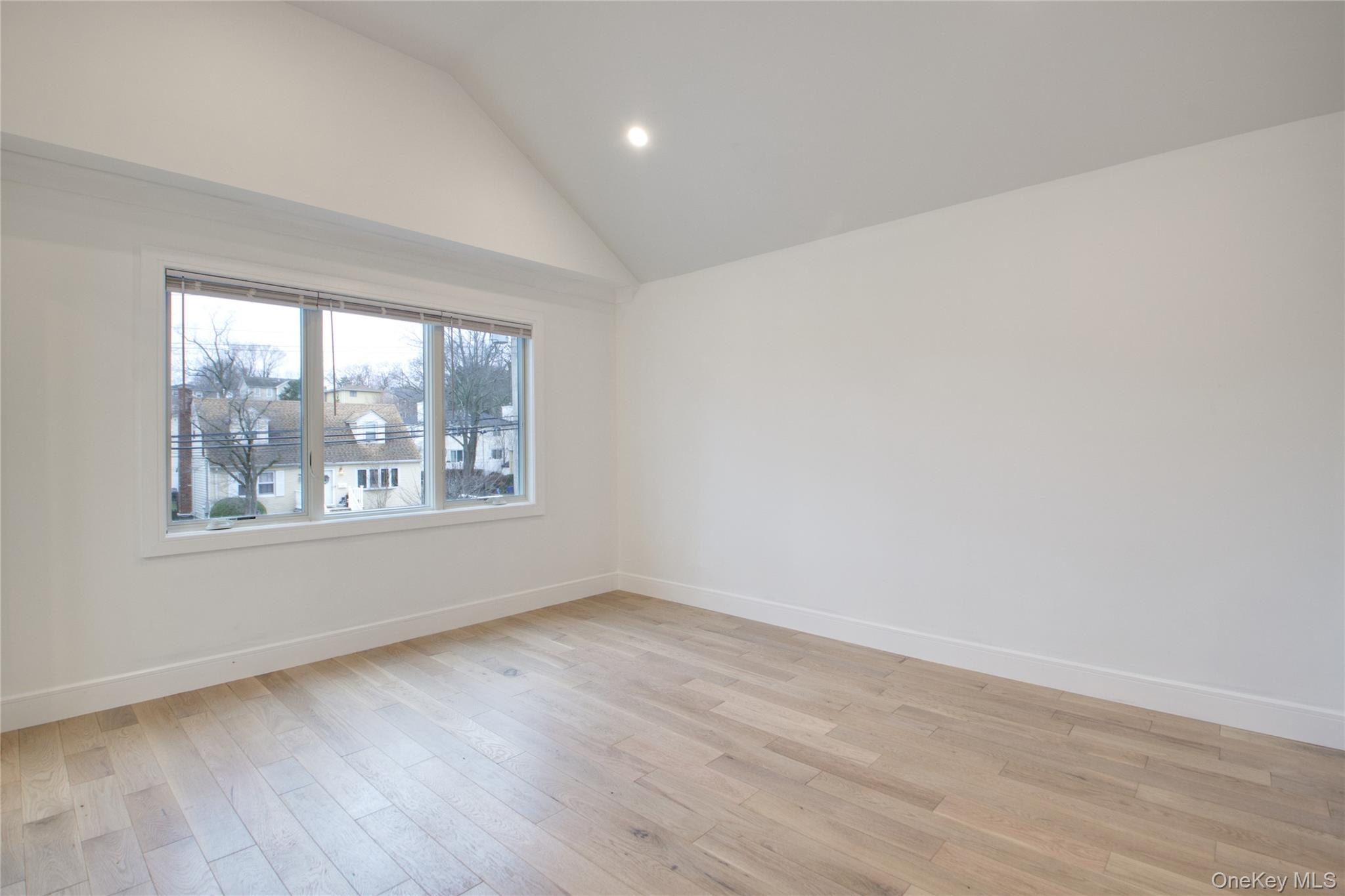 56 Kirkwood Road Port Washington, NY 11050 - Photo 30 of 46 an empty room with wooden floor and windows