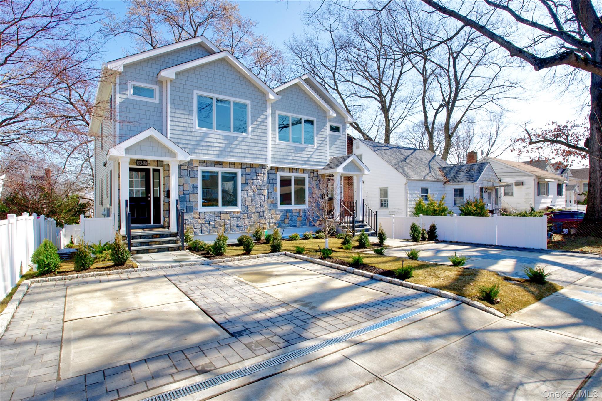 56 Kirkwood Road Port Washington, NY 11050 - Photo 3 of 46 a view of a brick house with couches chairs and a fire pit