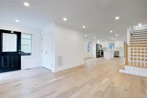a view of a kitchen with a sink and a refrigerator