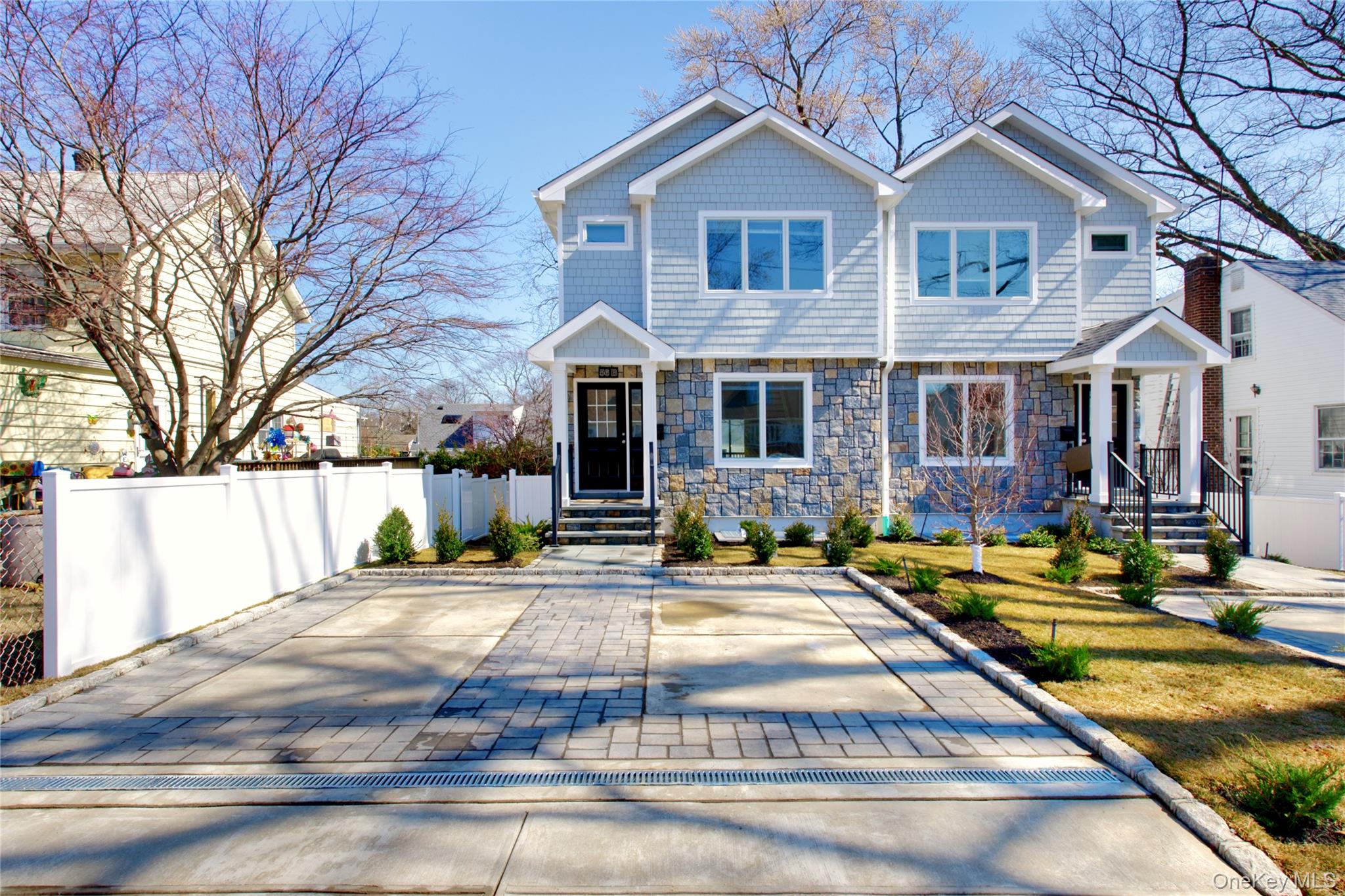 56 Kirkwood Road Port Washington, NY 11050 - Photo 34 of 46 a front view of a house with a yard
