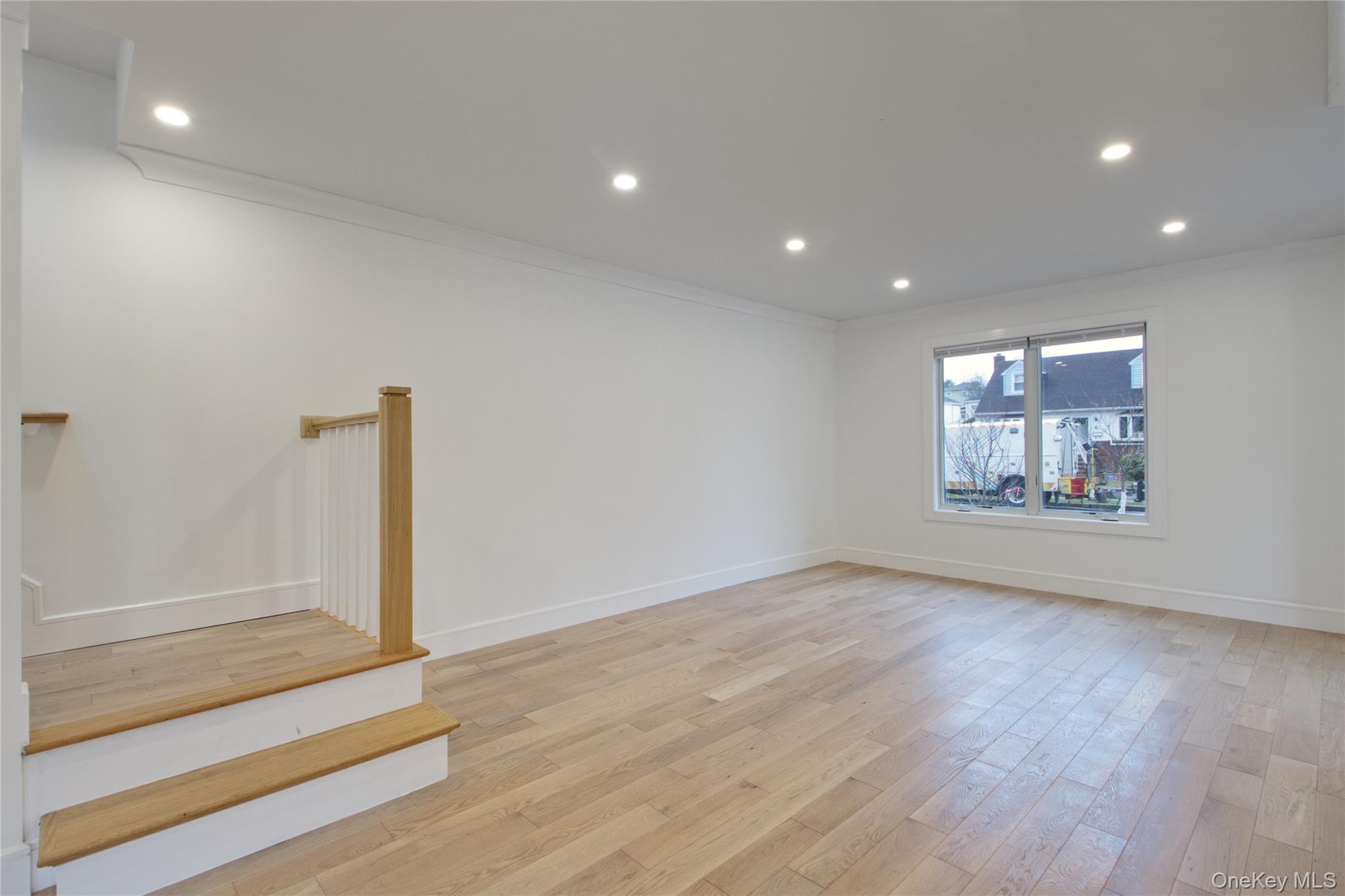 56 Kirkwood Road Port Washington, NY 11050 - Photo 37 of 46 an empty room with wooden floor and window