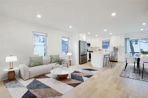 a living room with furniture and view of kitchen