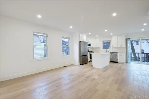 a view of a kitchen with a sink wooden floor and a window