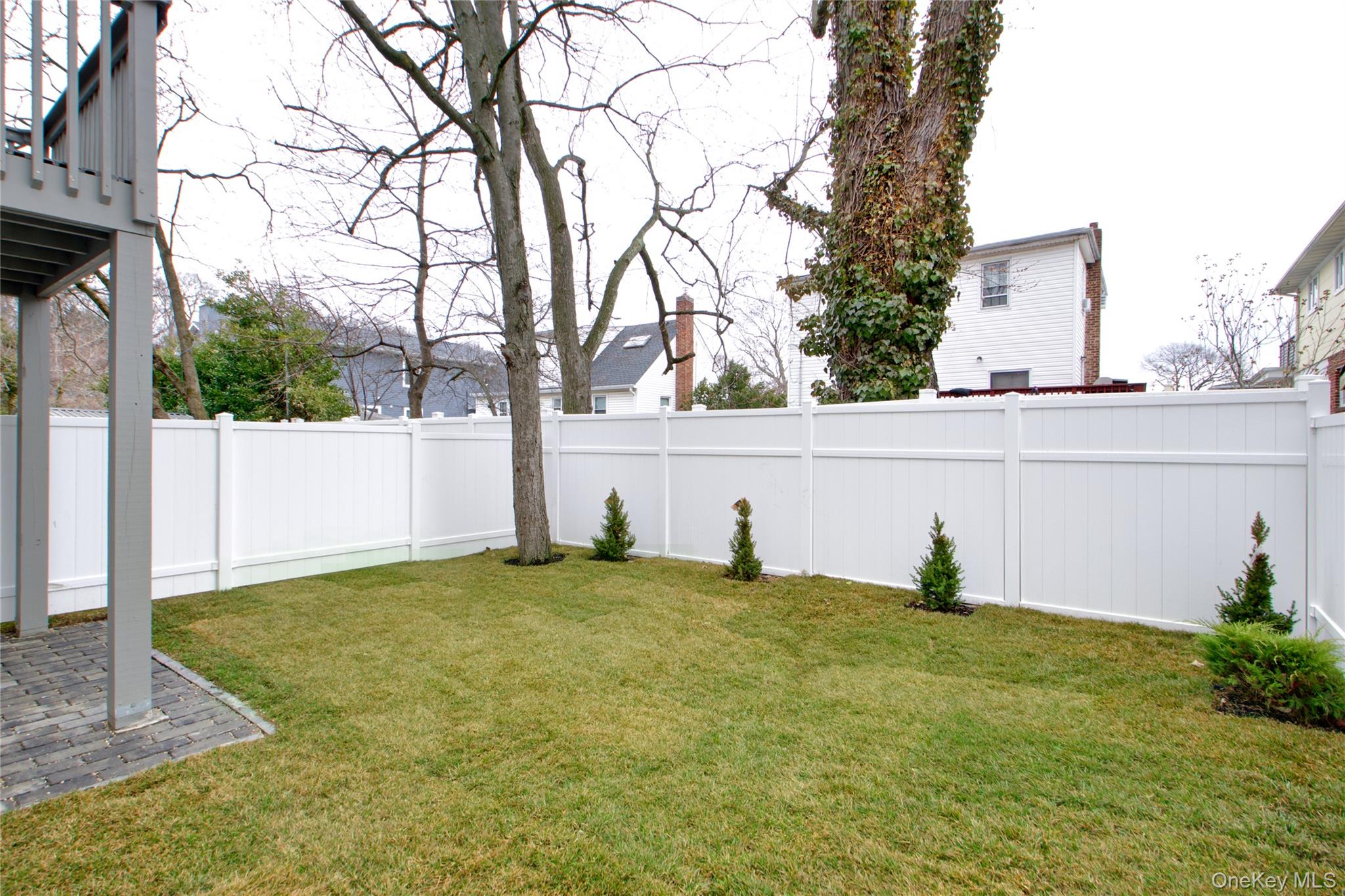 56 Kirkwood Road Port Washington, NY 11050 - Photo 42 of 46 a view of a backyard with plants and a tree