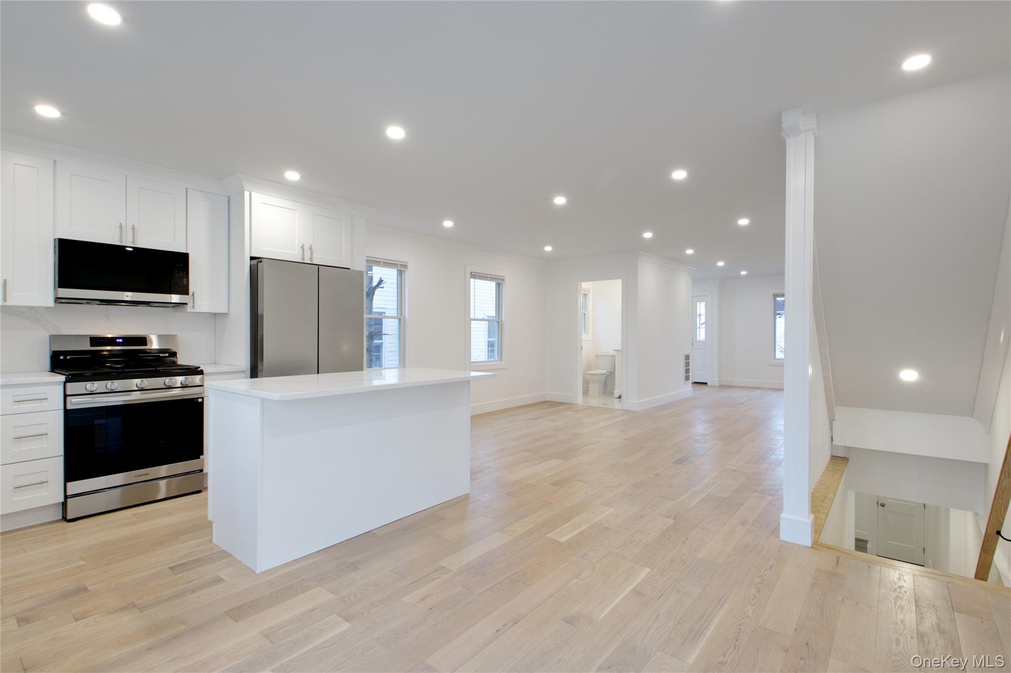 56 Kirkwood Road Port Washington, NY 11050 - Photo 10 of 46 a view of kitchen with kitchen island stainless steel appliances sink refrigerator and stove