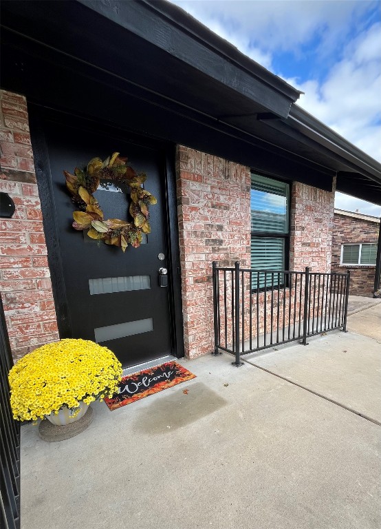 a view of a livingroom with wooden floor and a bed