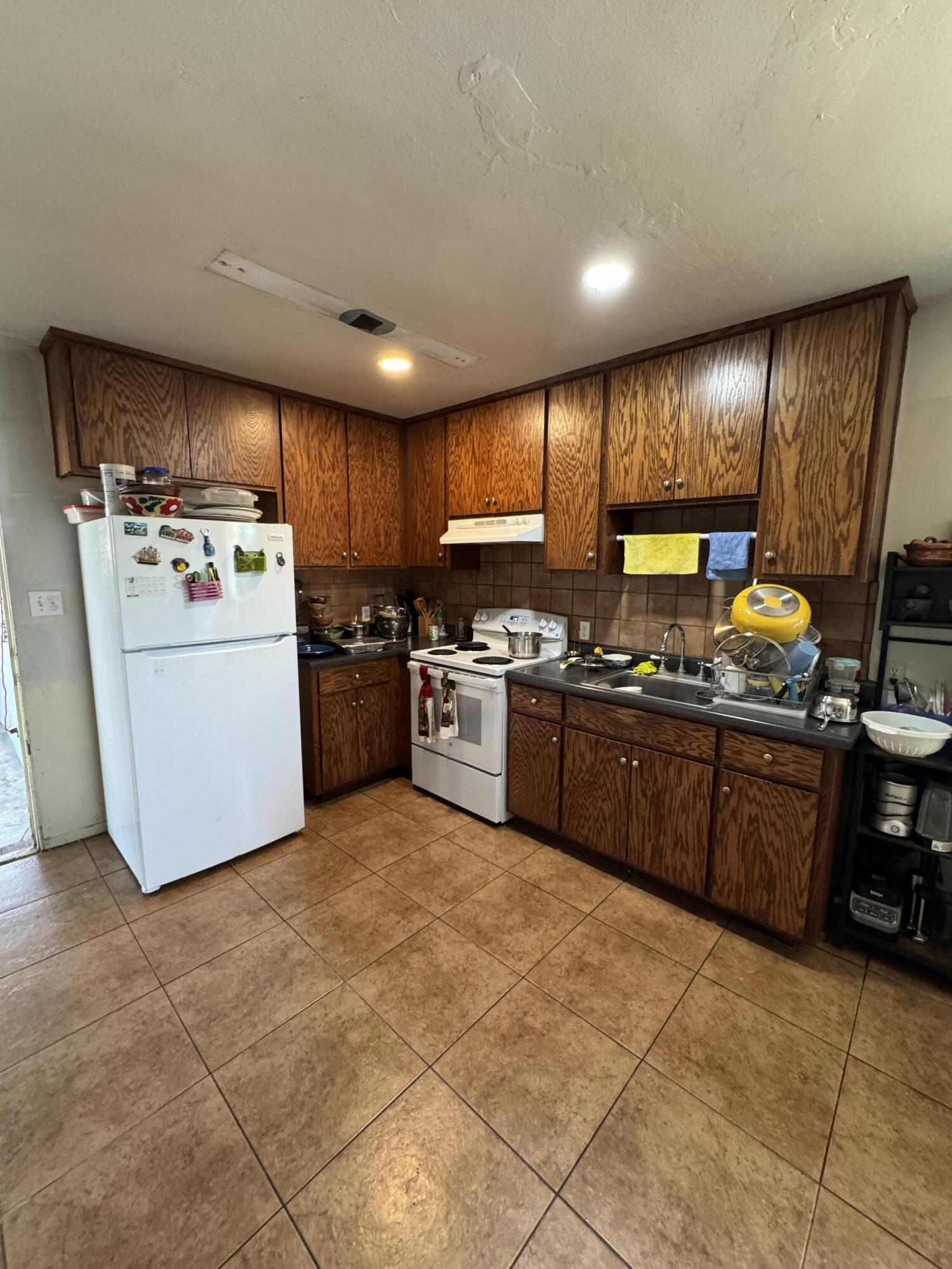 704 North Floral Street Visalia, CA 93291 - Photo 14 of 51 a kitchen with a sink a counter top space stainless steel appliances and cabinets