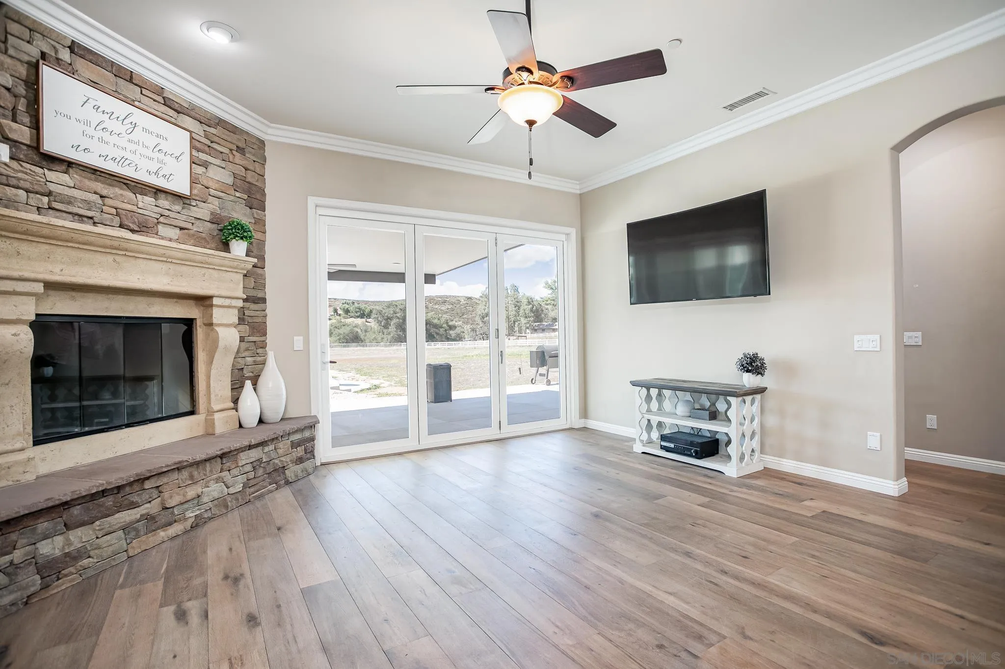 1090 Heritage Ranch Road Ramona, CA 92065 - Photo 11 of 49 a living room with furniture a fireplace and a flat screen tv
