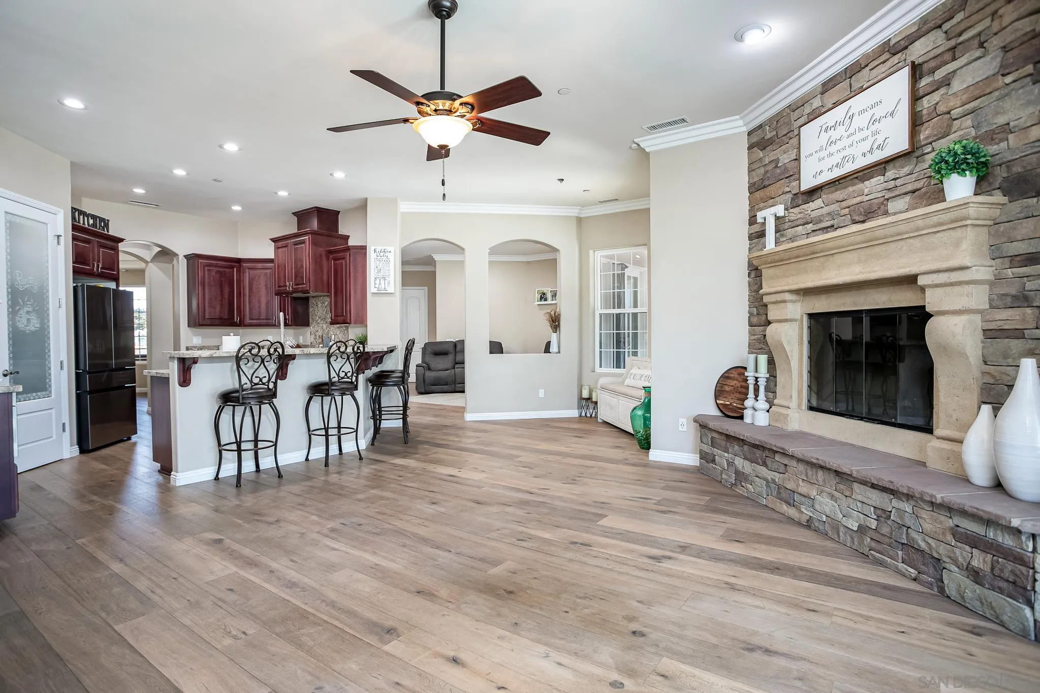 1090 Heritage Ranch Road Ramona, CA 92065 - Photo 12 of 49 a view of a dining room with furniture a fireplace and wooden floor