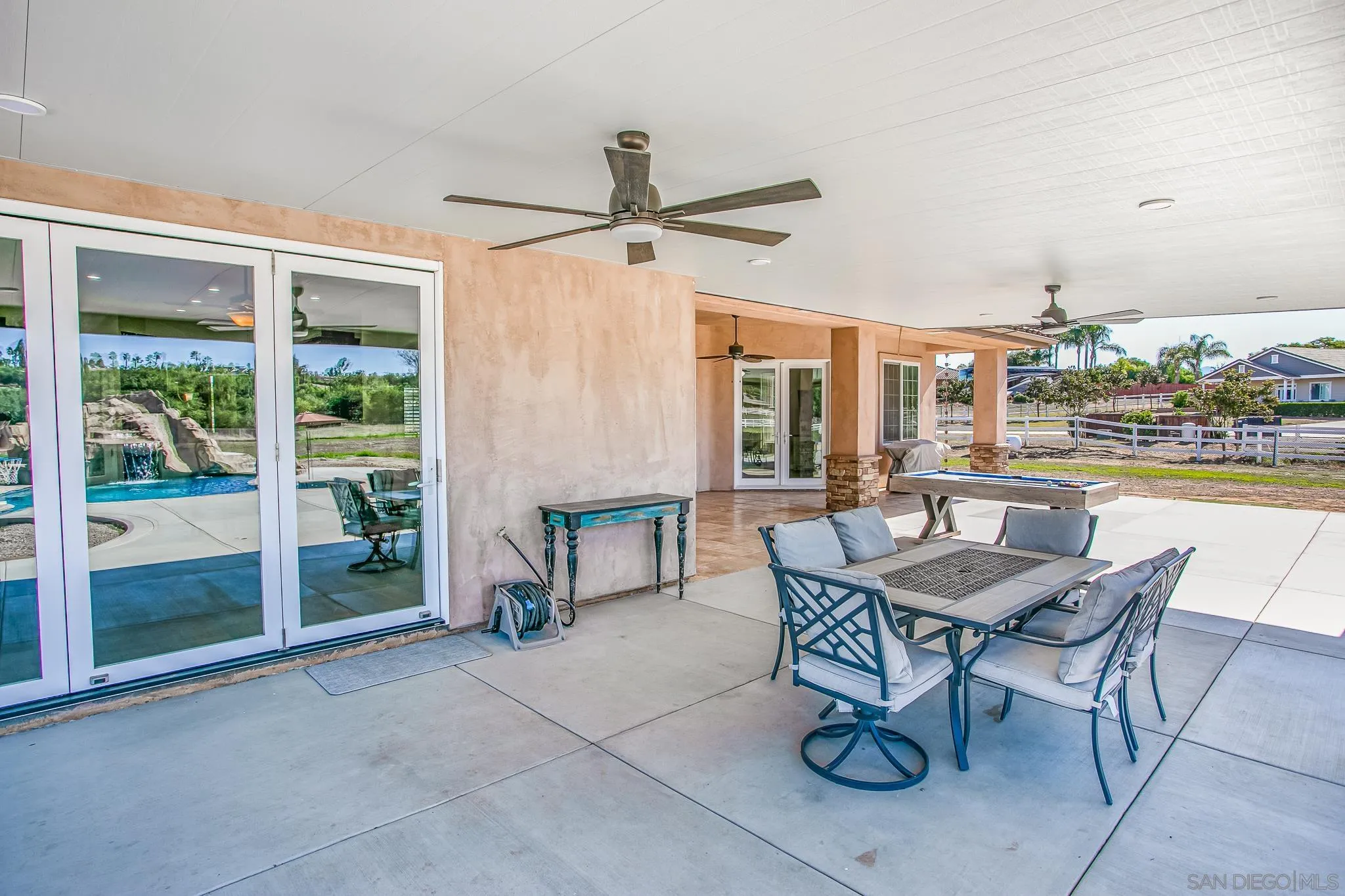 1090 Heritage Ranch Road Ramona, CA 92065 - Photo 34 of 49 a dining room with furniture and a floor to ceiling window