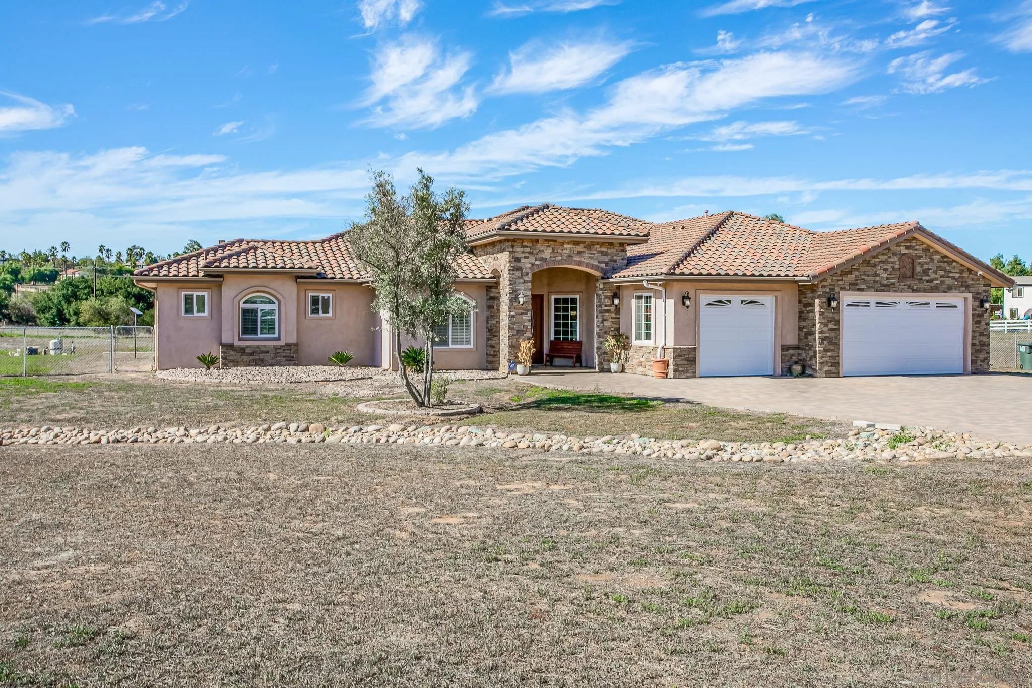 1090 Heritage Ranch Road Ramona, CA 92065 - Photo 6 of 49 a front view of a house with a garden
