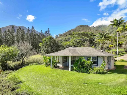 an aerial view of a house with a yard