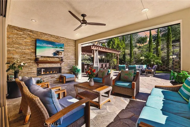 a living room with patio furniture and a large window