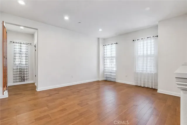 a view of a room with a large window and a clock on the wall