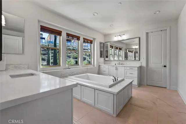 a spacious bathroom with a granite countertop sink mirror and shower