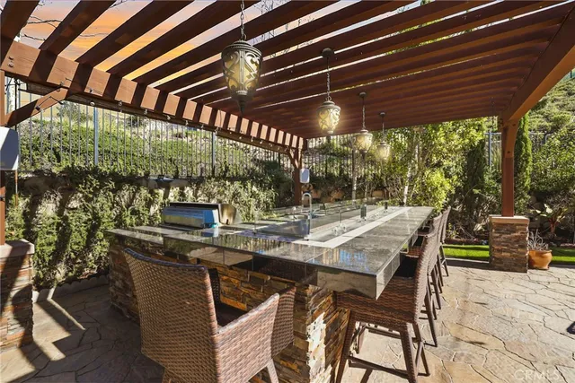 a view of a chairs and table in the patio and a wooden fence