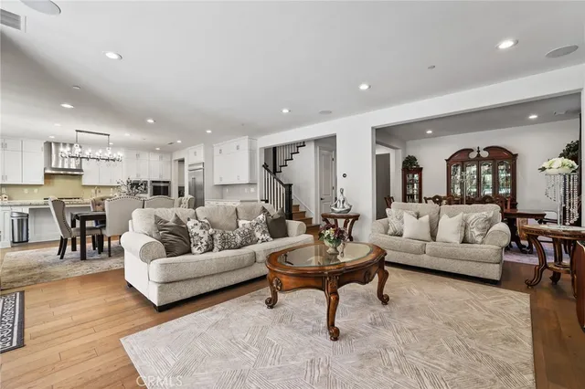 a living room with furniture and a view of kitchen
