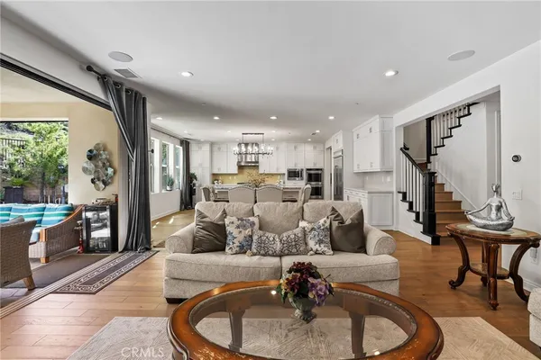 a living room with furniture and a wooden floor