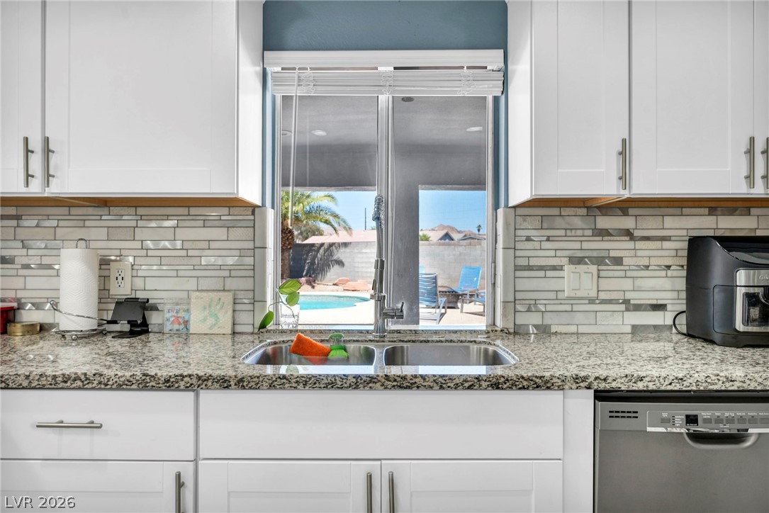 5882 Rio Tinto Way Las Vegas, NV 89110 - Photo 31 of 56 An inviting kitchen with a granite countertop and a pool view.