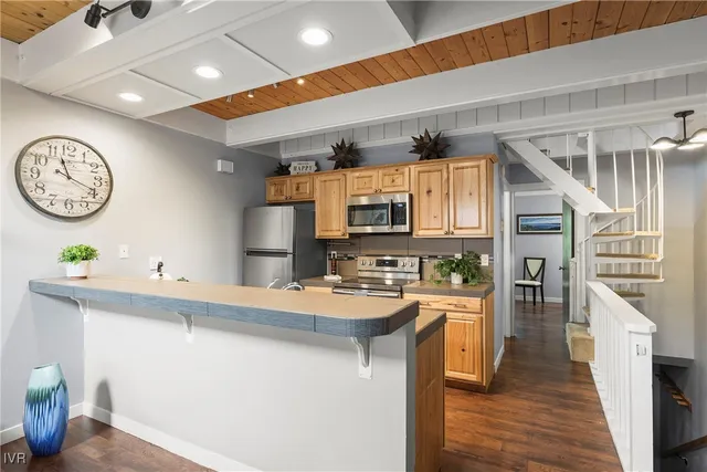 a kitchen with stainless steel appliances granite countertop a sink and stove top oven