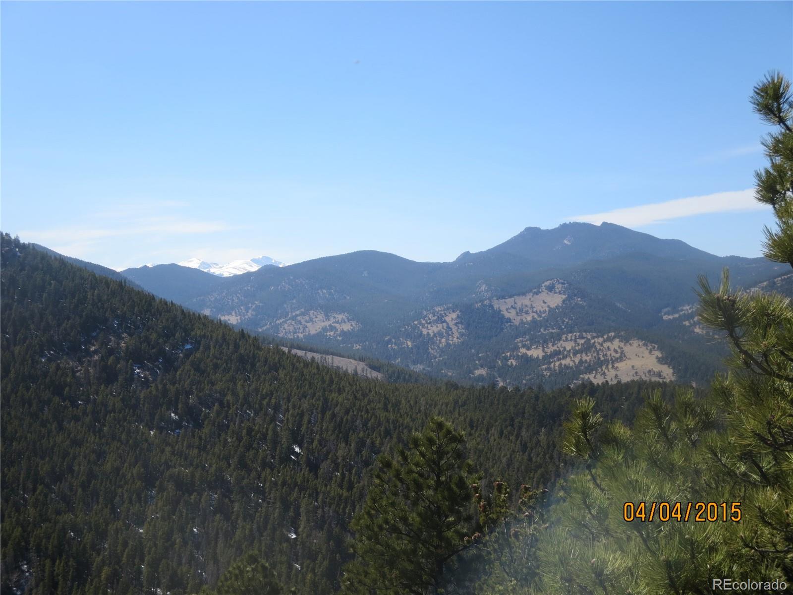 8077 Drew Hill Road Golden, CO 80403 - Photo 6 of 6 a view of a mountain range with lush green forest