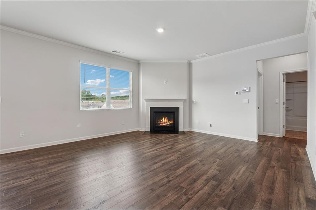 96 Quail Bend Way Dallas, GA 30157 - Photo 13 of 57 a view of an empty room with wooden floor and a window