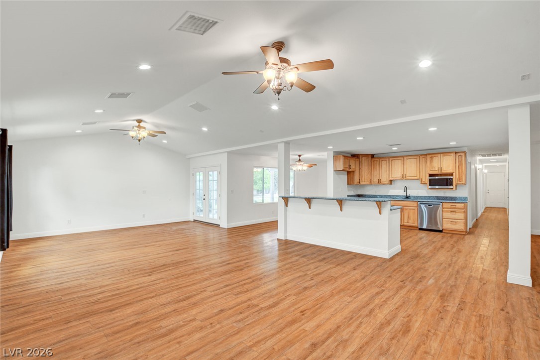 1810 Pinto Road Henderson, NV 89002 - Photo 13 of 53 An open concept living area connects seamlessly with the kitchen, creating an inviting space for gathering.